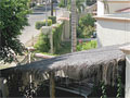 Ground-level enclosed garage with palapa roof