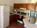 fully firnished kitchen, large counters
and adjacent dining room area, next to fully-furnished
laundry room